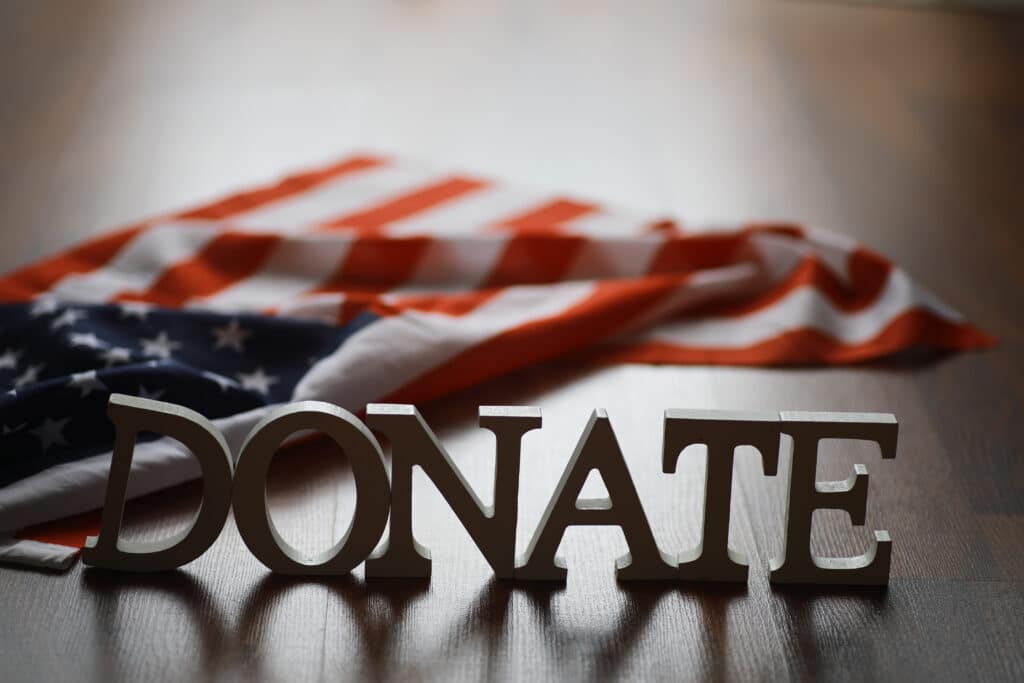 donate sign with american flag background patriotic charity fundraising support concept image